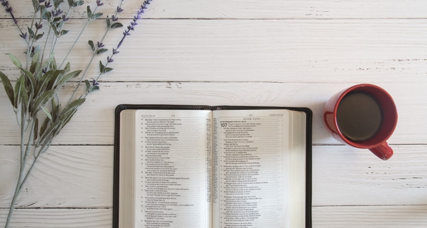 Bible on table open tp Psalm with coffee