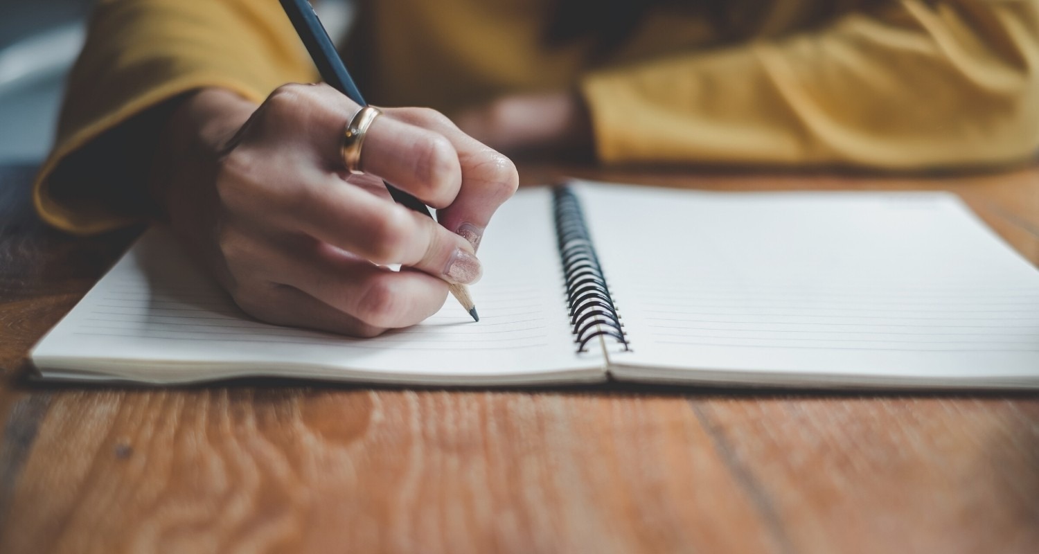 Woman writing in Journal