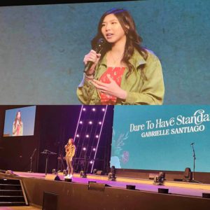 Gaby Santiago speaking at a Women's Conference